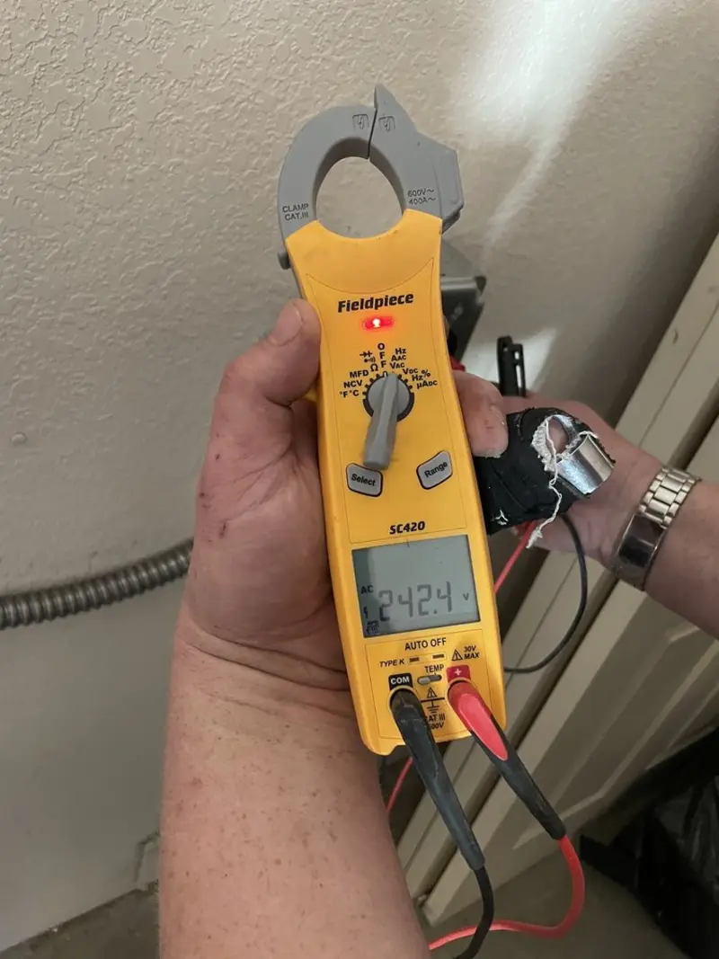 Voltage testing with clamp meter during Ceiling Fan Installation in Maine